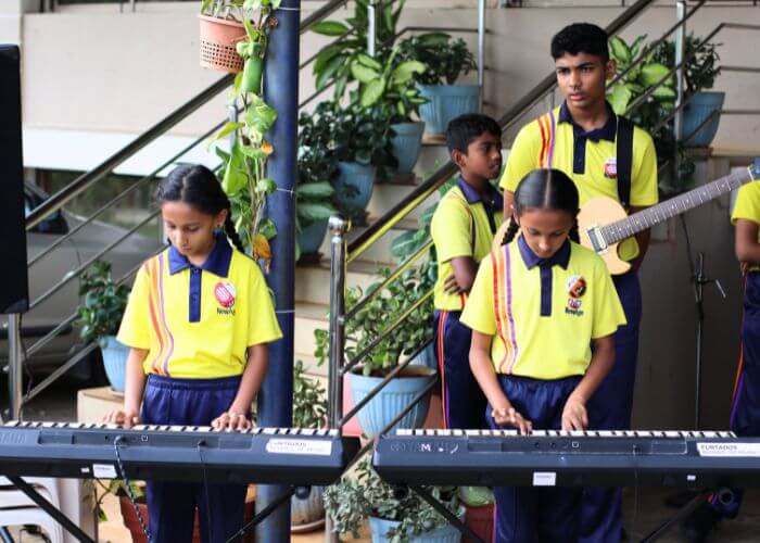 Students performing on stage during a talent show at NewAge World School