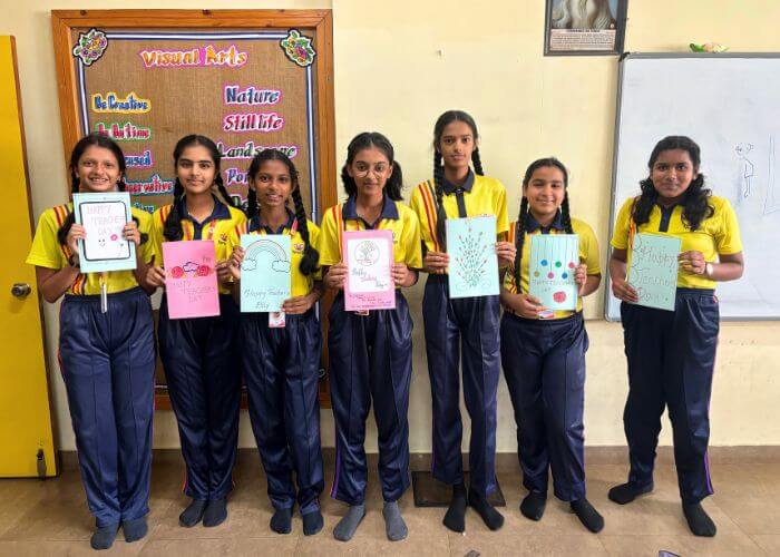 Students displaying their creative artwork and certificates at NewAge World School