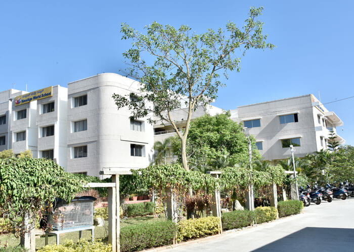 Campus view of NewAge World School with well-maintained greenery.