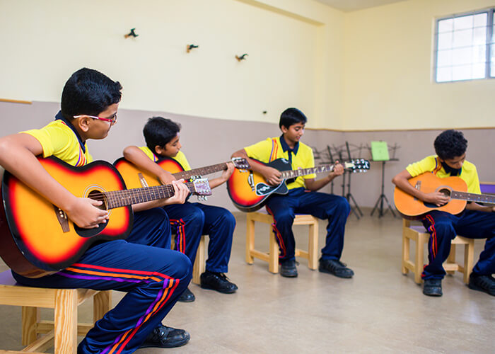 Children performing a musical recital during a school event at NewAge World School